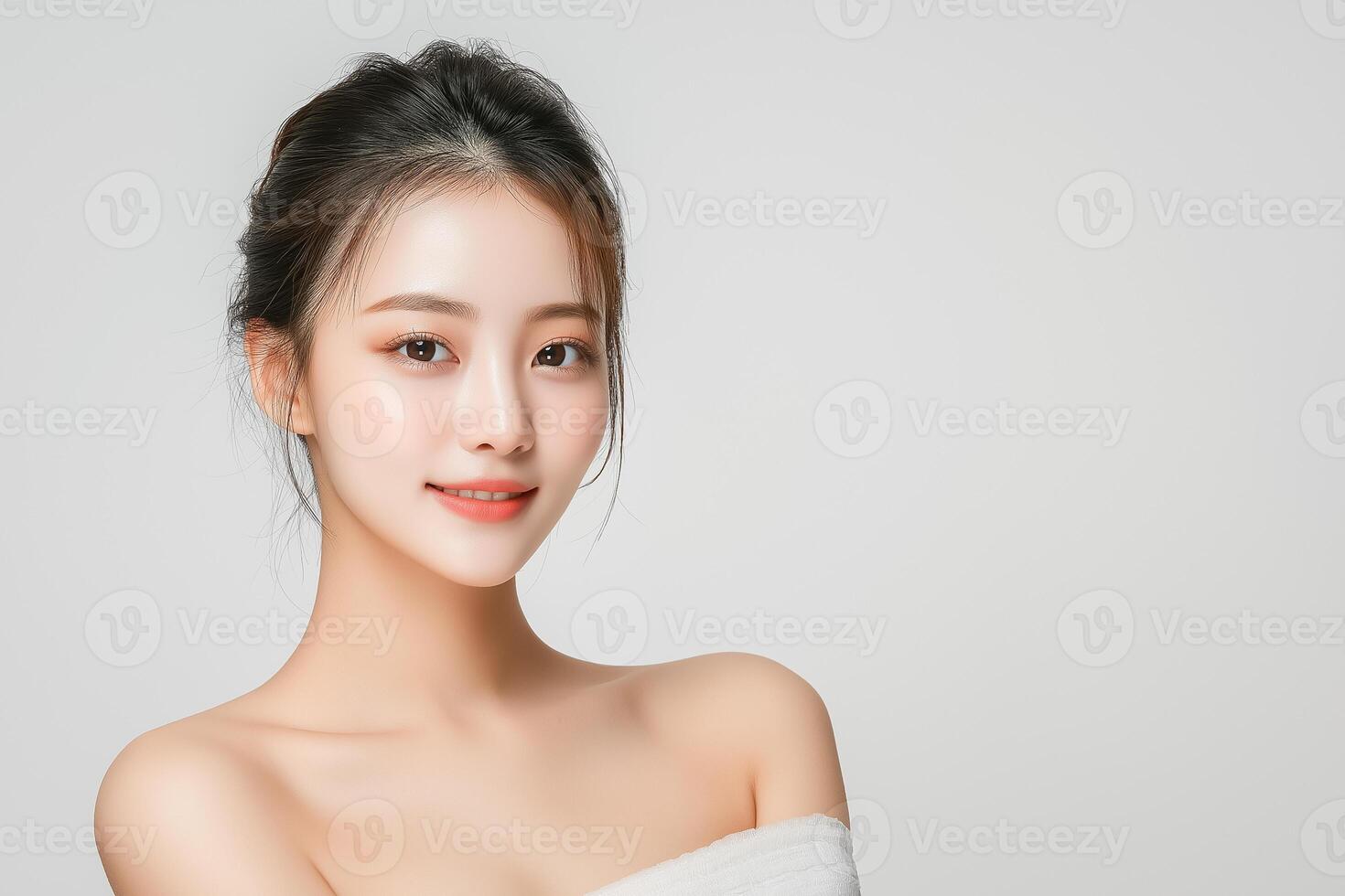 Beautiful asian woman in towel posing for the camera photo