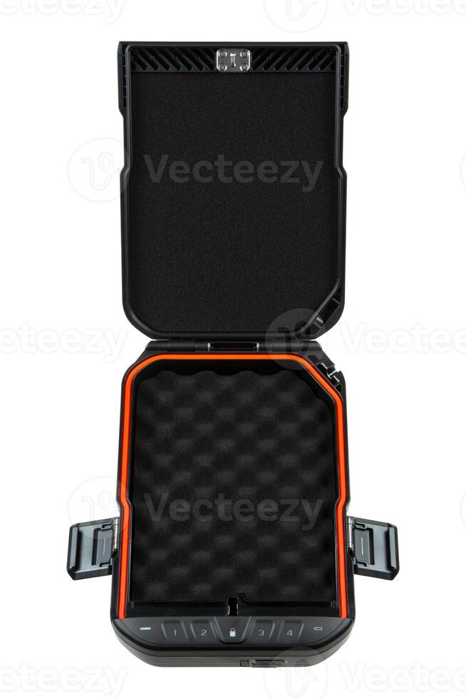 Open portable black safe with an orange lining, featuring a foam interior for storing weapons or valuables, isolated on a white back. photo