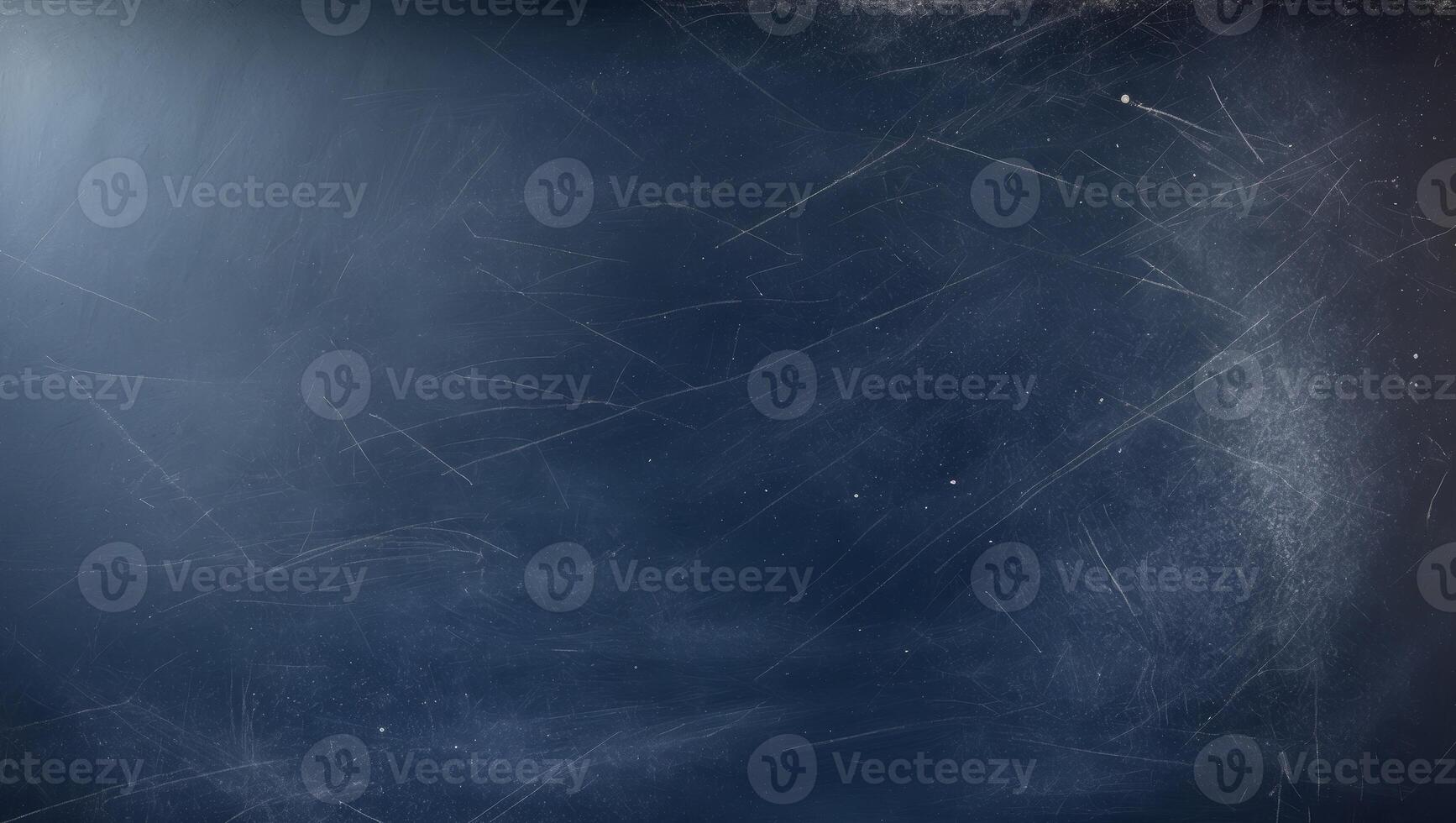A copy space image of a dark blue chalkboard with traces of erasing creating a textured background. photo