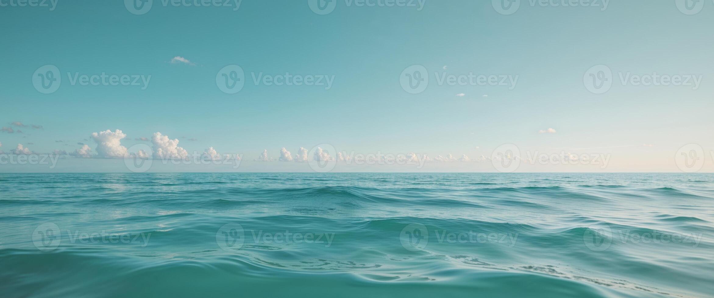 A view of the ocean from above with clouds in the sky photo