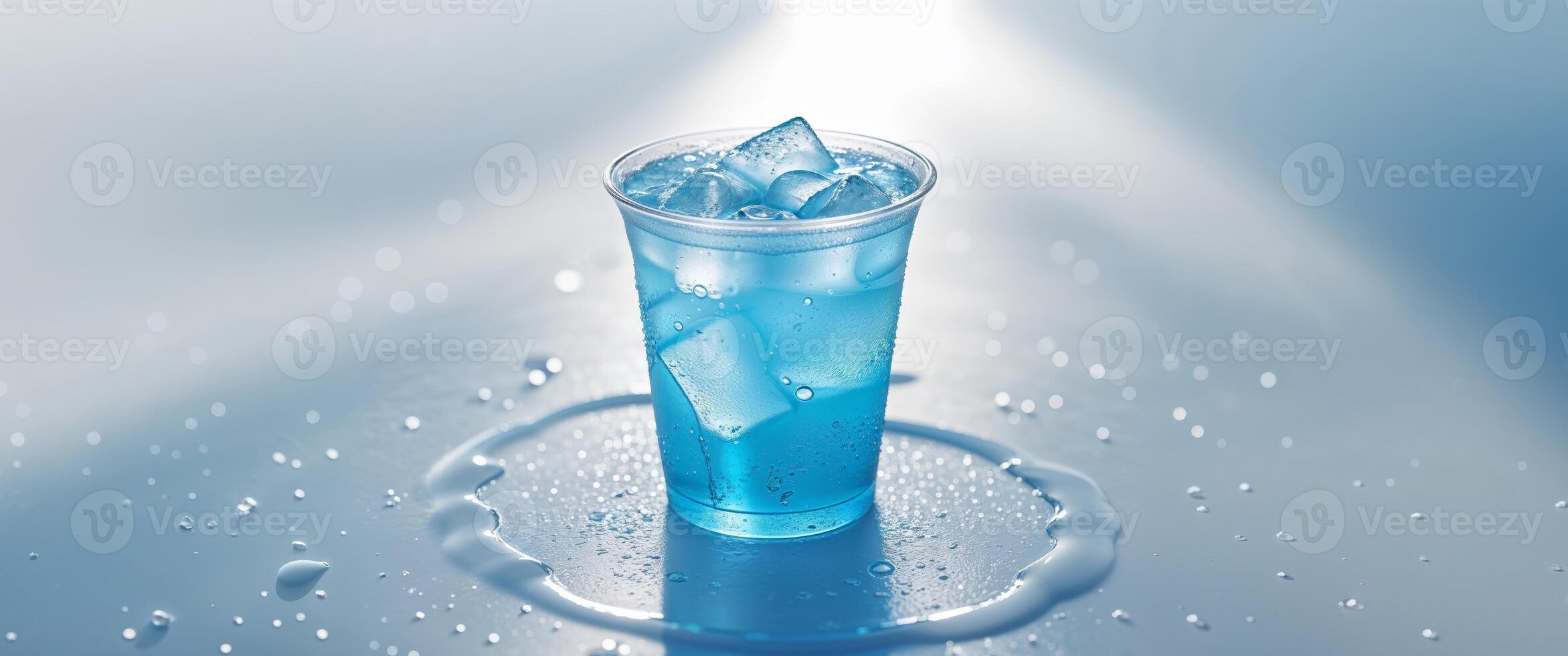 A blue drink in a glass with ice cubes photo