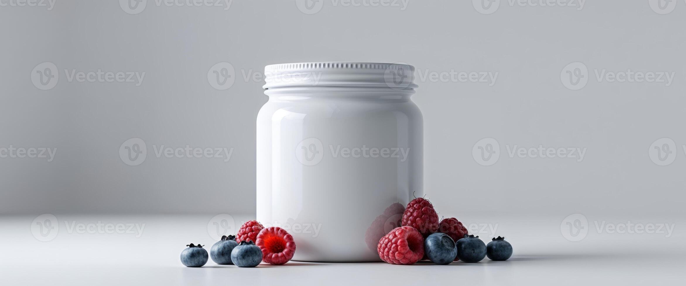 A bottle of vitamins and berries on a table photo