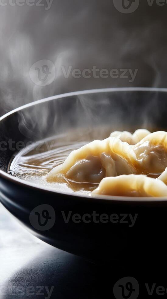 Delicate dumplings in rich chicken broth against a silky background with gentle steam rising photo