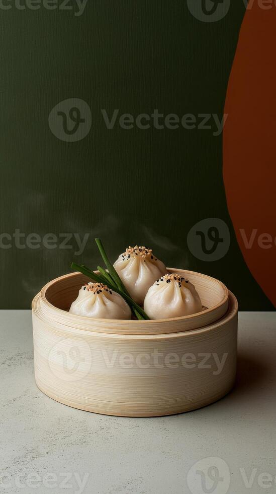 Bamboo basket filled with freshly made dumplings on a minimalist table with a green wall in the background photo