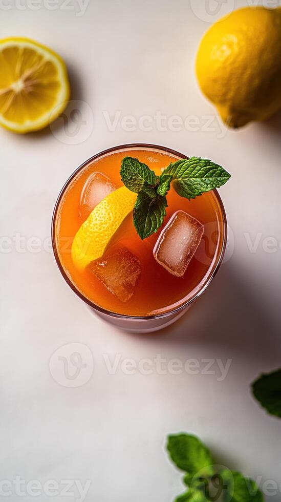 Refreshing turmeric iced tea garnished with lemon and mint on a sunny afternoon in a serene cafe setting photo