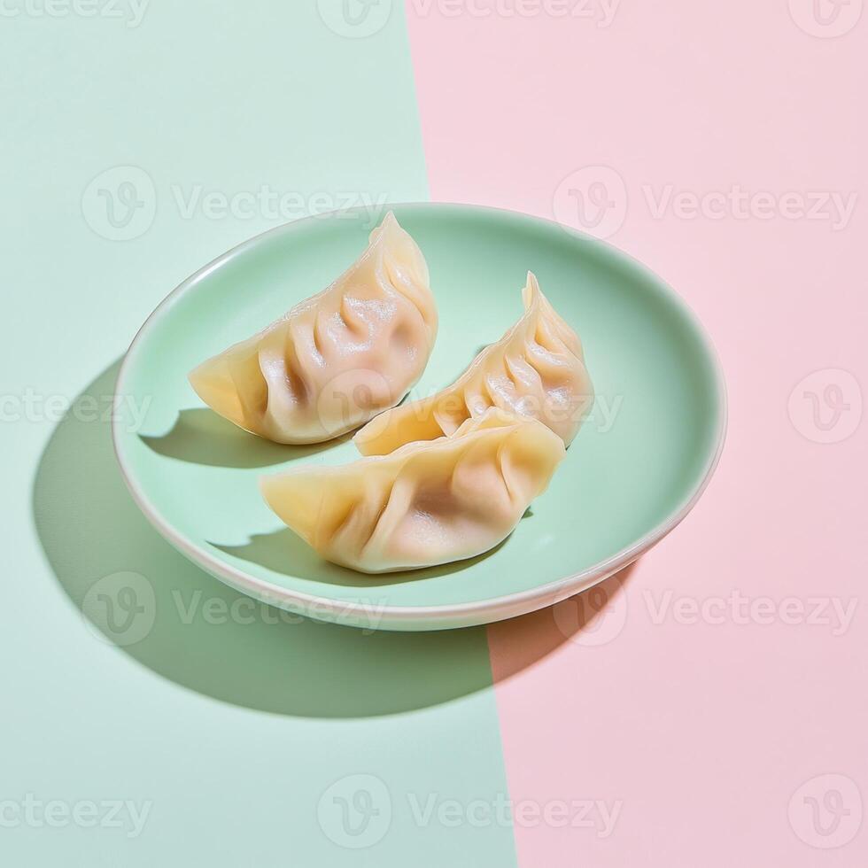 Delicately sliced cabbage and pork dumplings served on a pastel plate during a vibrant culinary presentation photo