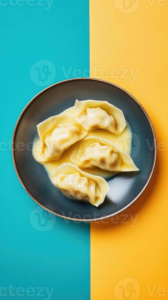Dumplings in creamy sauce beautifully arranged on a vibrant plate against contrasting backgrounds photo