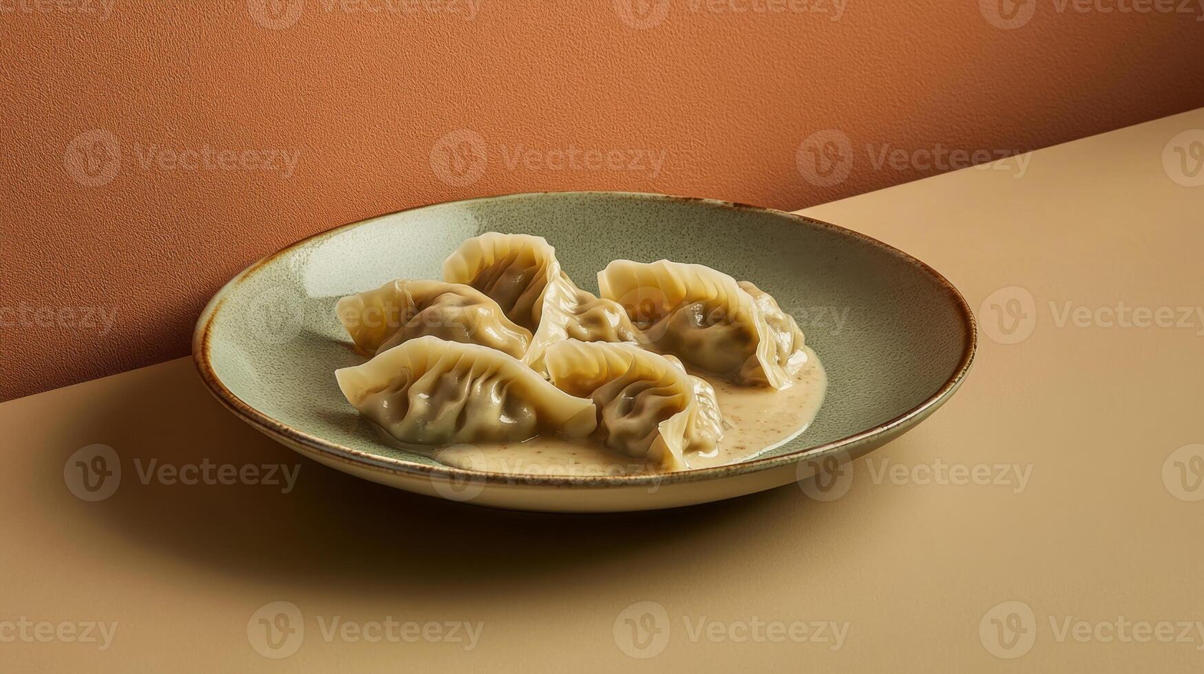 Dumplings in a creamy sauce arranged artfully on a minimalist plate set against a warm colored backdrop photo