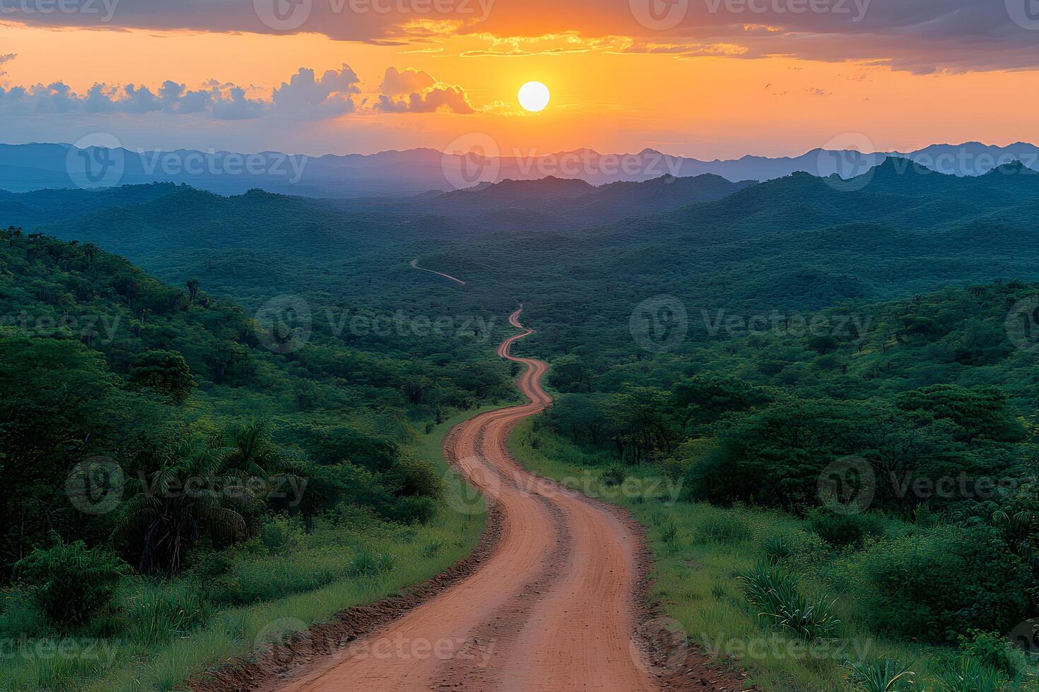 Serene Sunset Over Winding Dirt Road in Lush Green Landscape for Tranquil Travel Inspiration photo