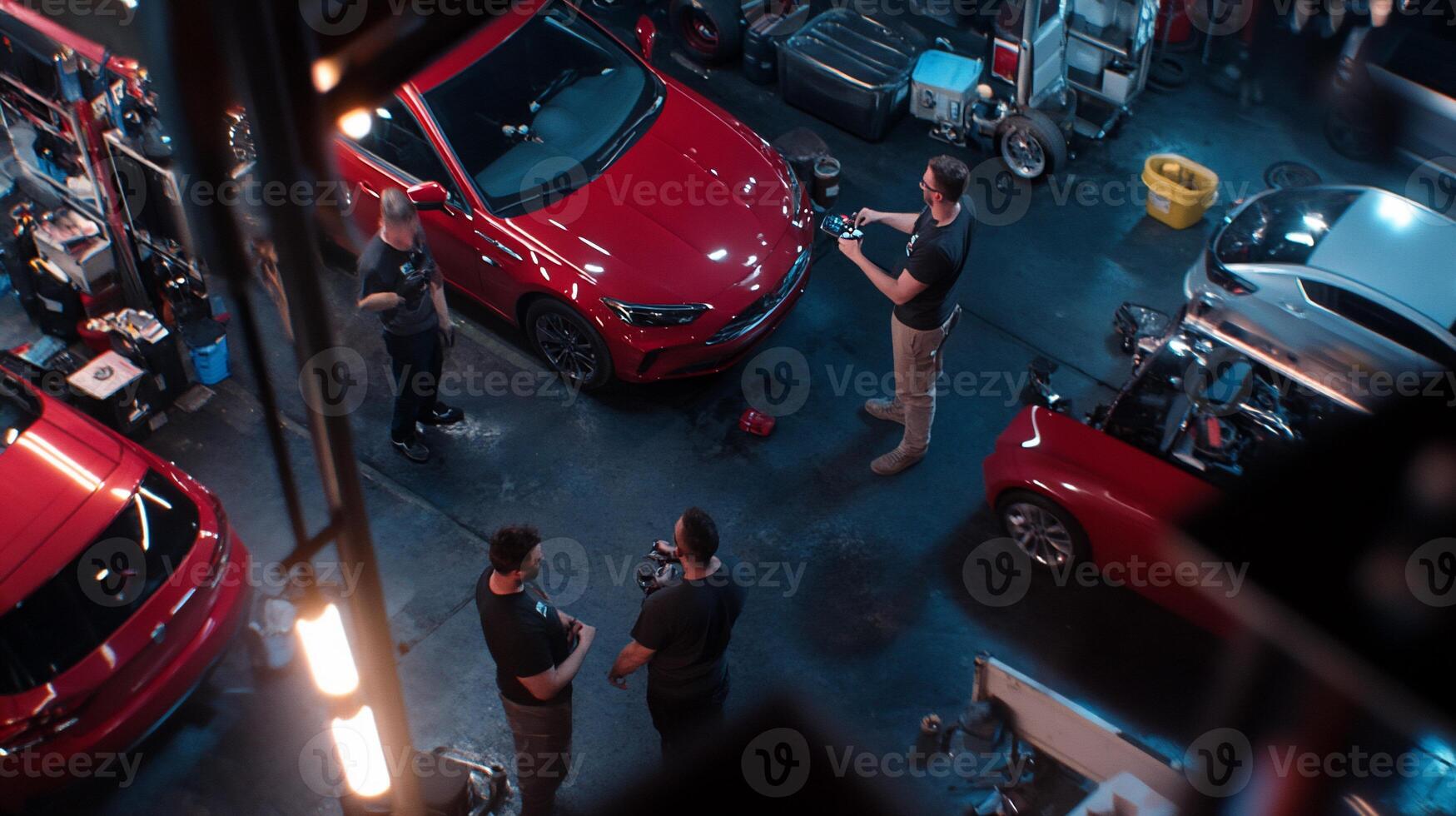 Garage car detailing, multiple workers, top-down view photo