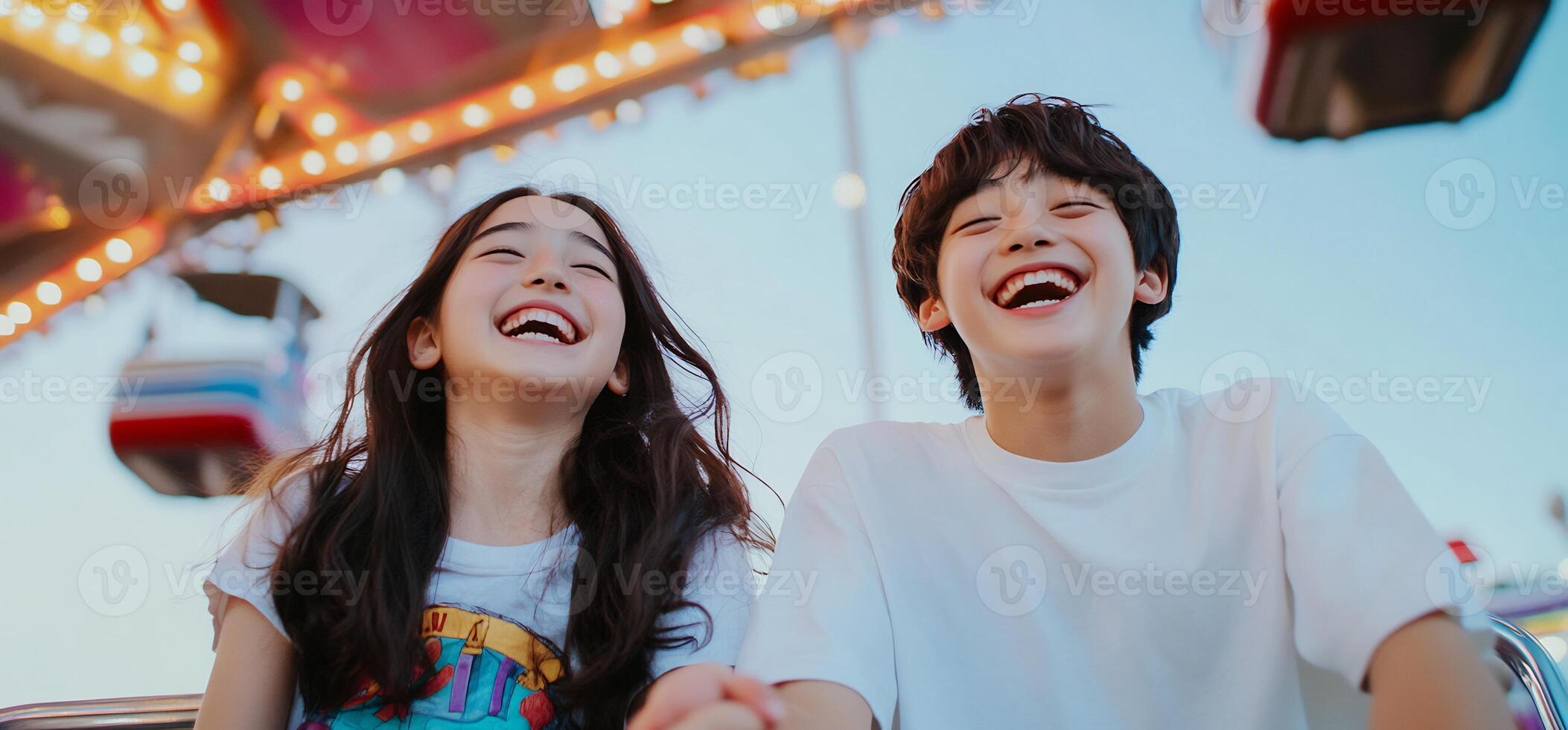 Happy teenagers on amusement park ride photo