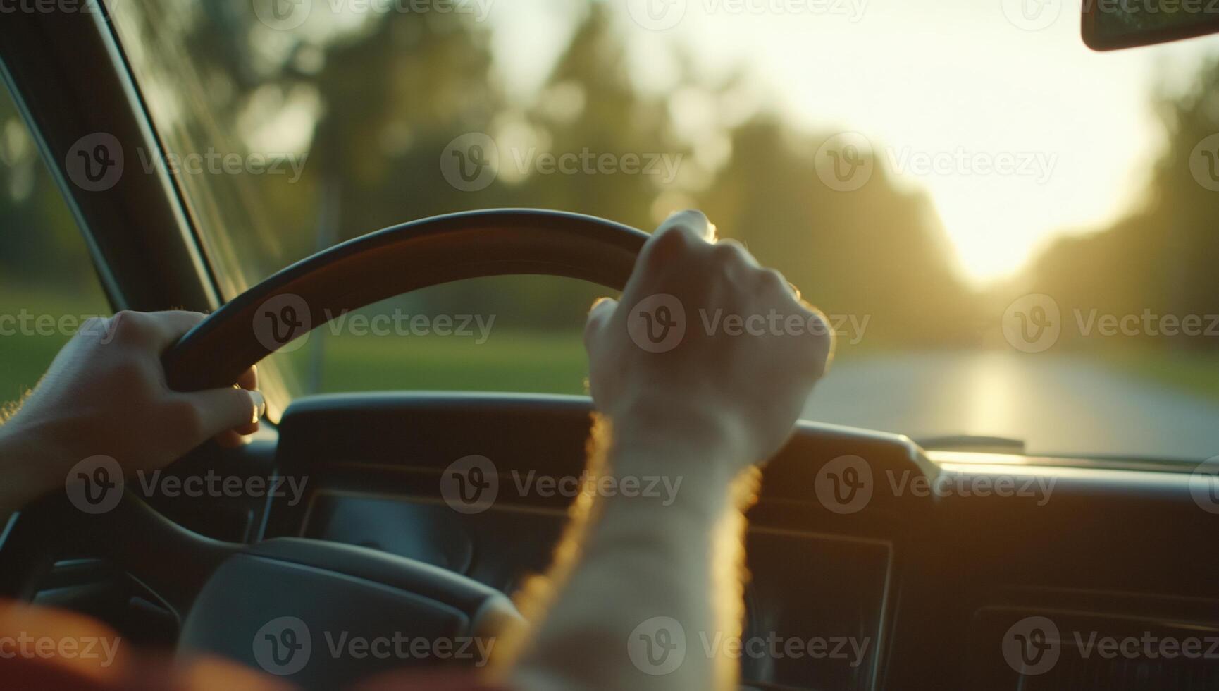 A person driving a car with the sun setting behind them photo