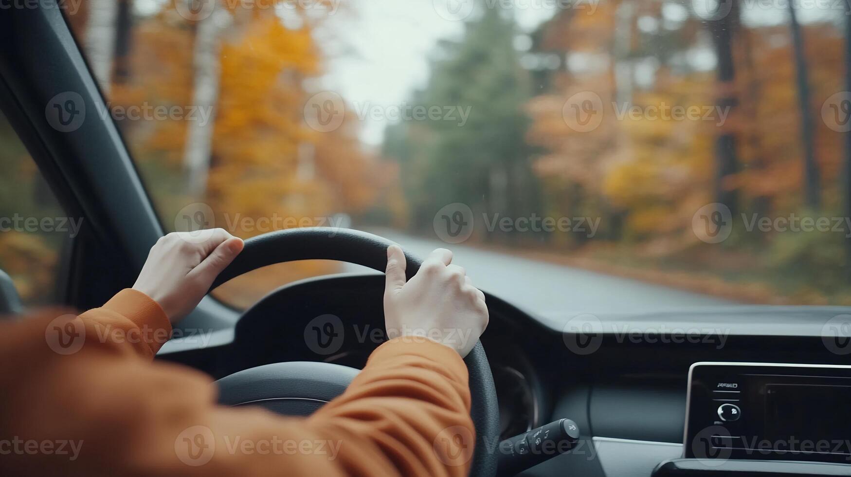 Autumn road trip Person driving through colorful forest. photo