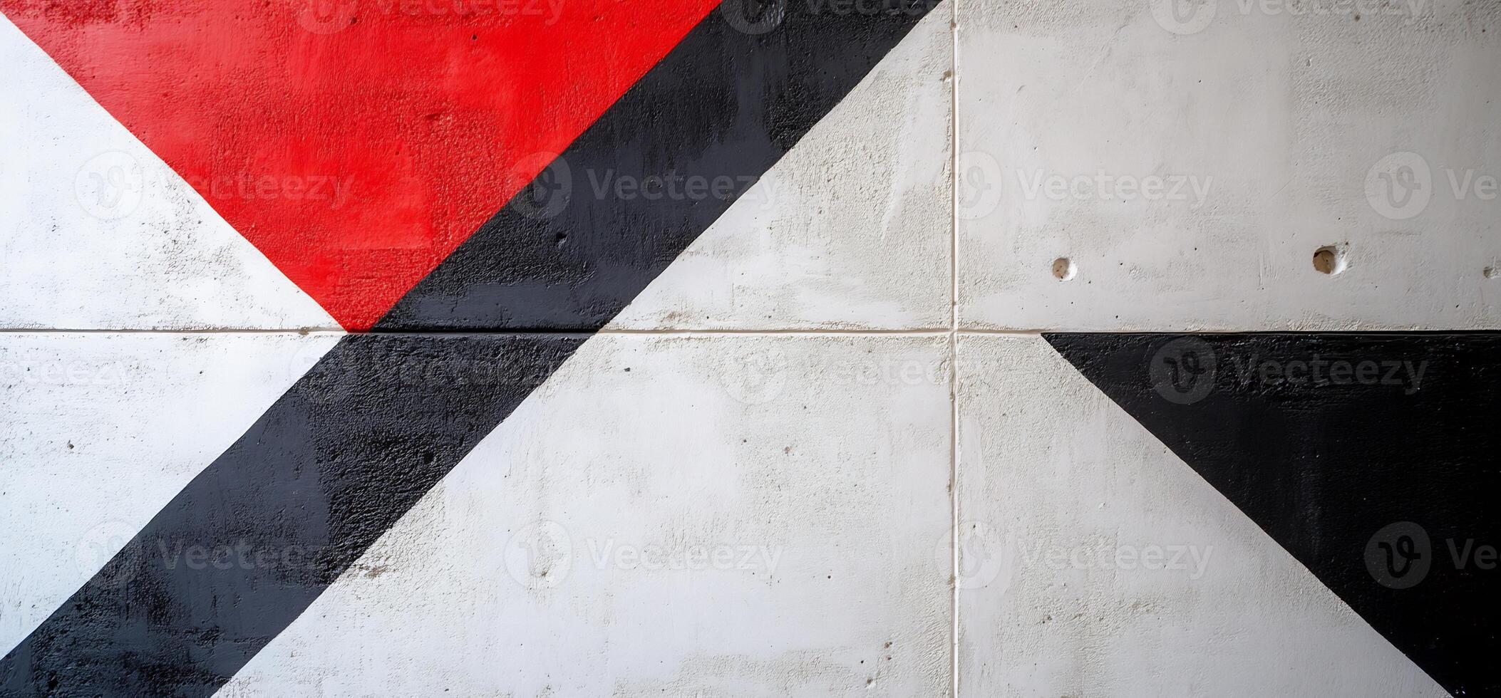 A black, white and red wall with a triangle painted on it photo