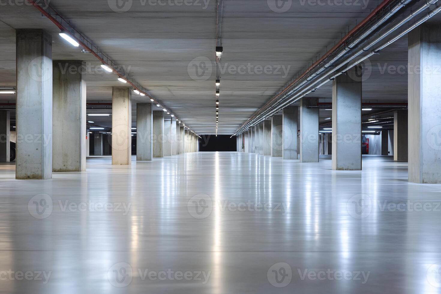 Empty modern underground parking garage with concrete pillars and bright lighting. photo