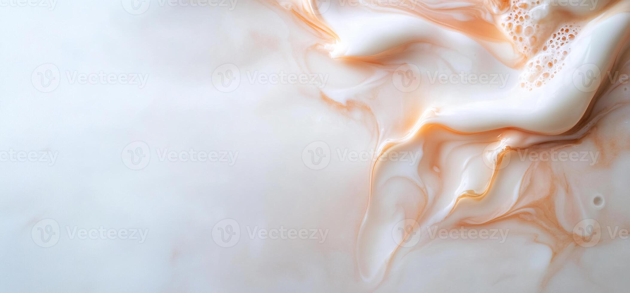 Abstract swirls of cream and peach liquid. photo