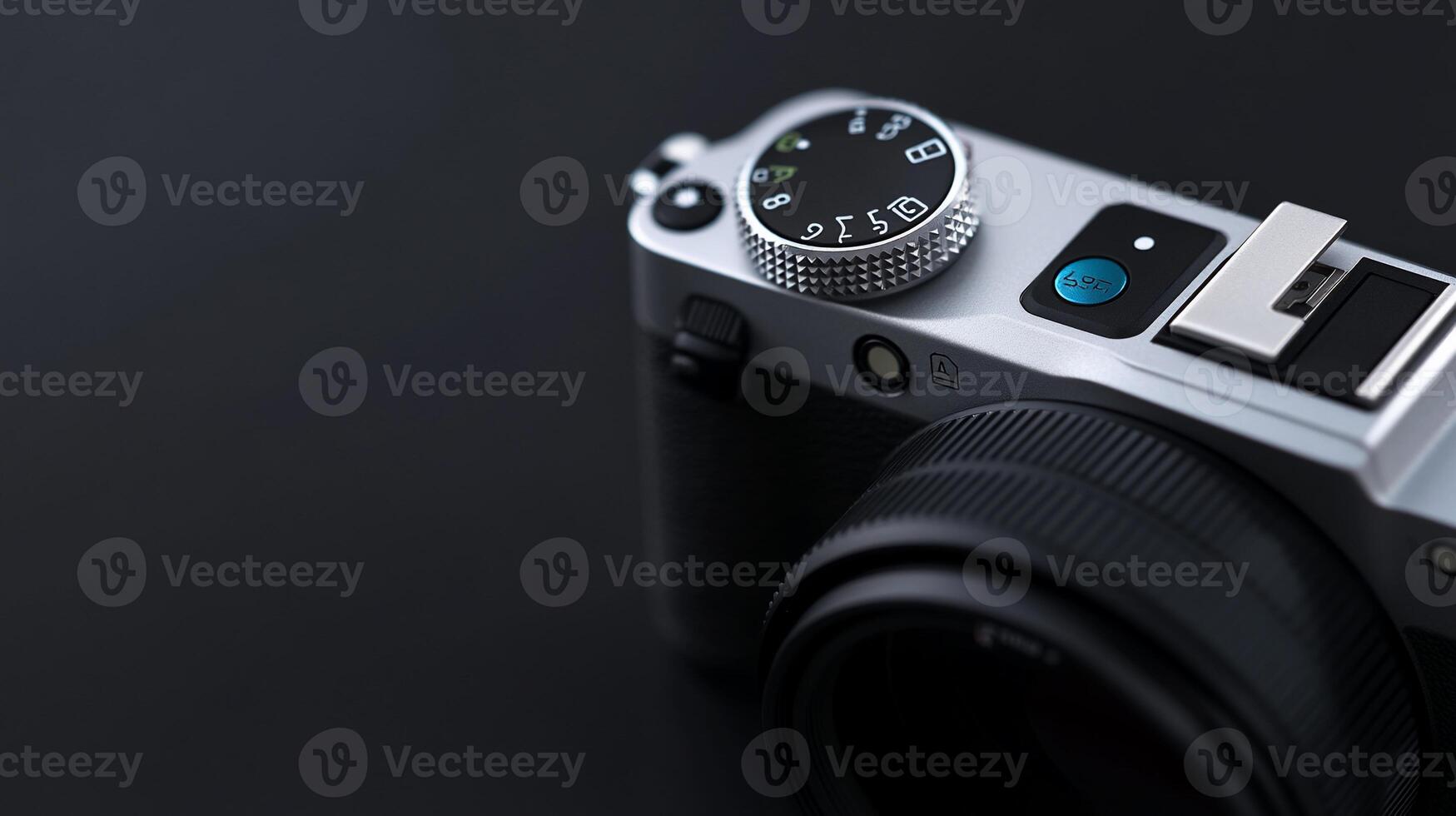 Close-up of a silver digital camera on a dark background. photo