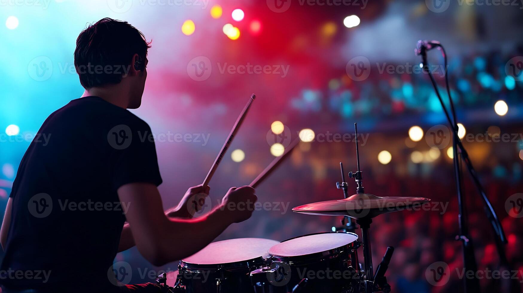 A drummer playing drums at a concert photo