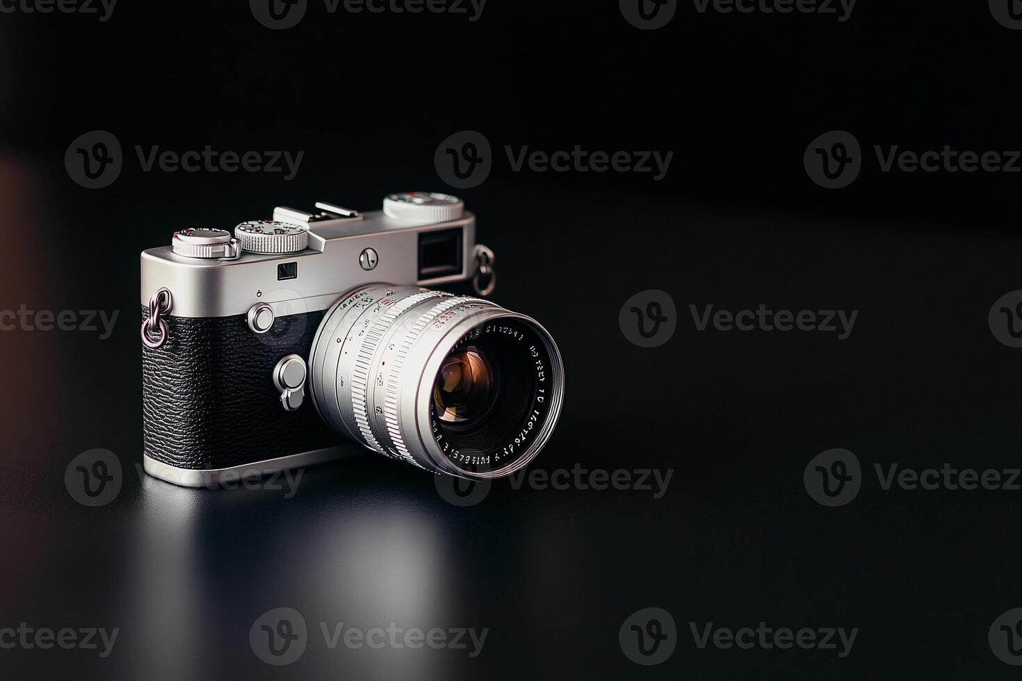 Silver rangefinder camera on dark background. photo