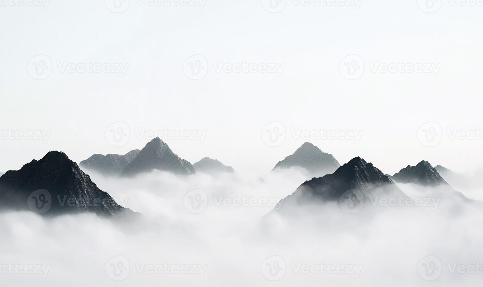 Misty mountain range peaks emerging from clouds. photo