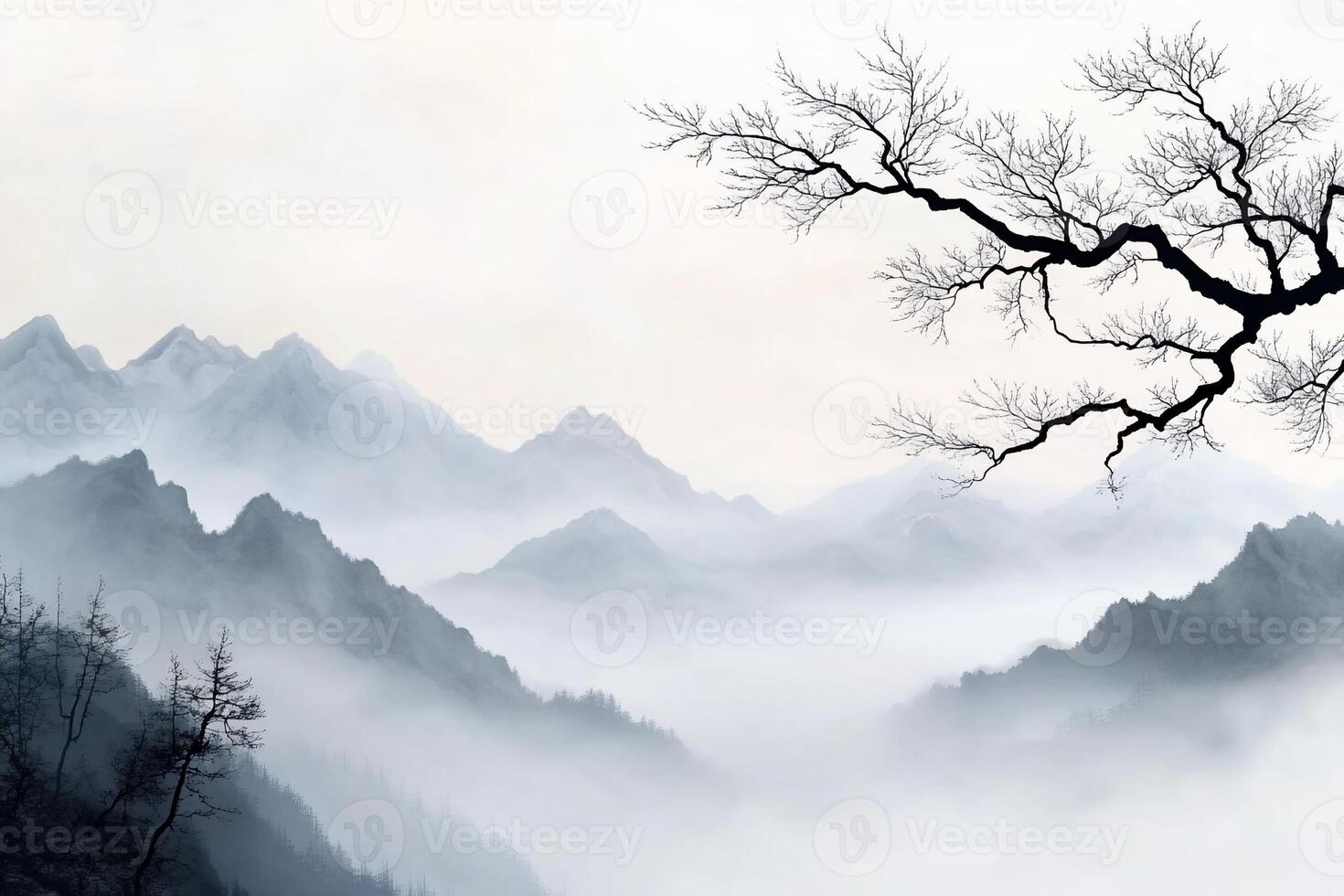 Misty mountain landscape with a barren tree branch. photo