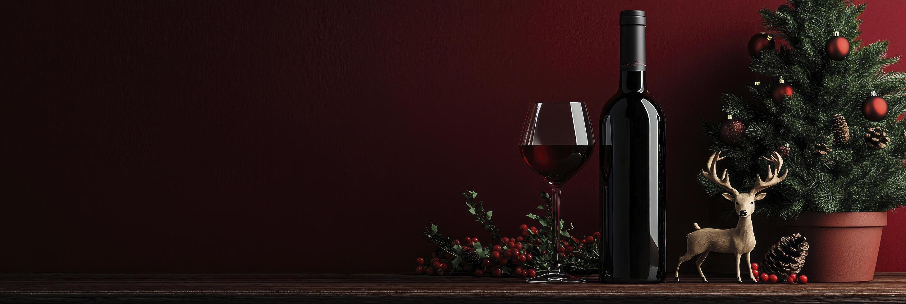 A bottle of red wine, a glass, and a deer decoration next to it, a Christmas tree in a pot on dark red background photo