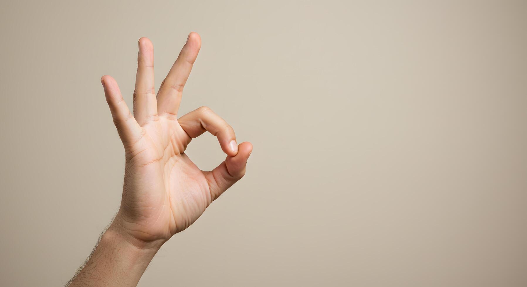 OK Hand Gesture Photography Against Neutral Background A Simple Sign of Approval and Agreement photo