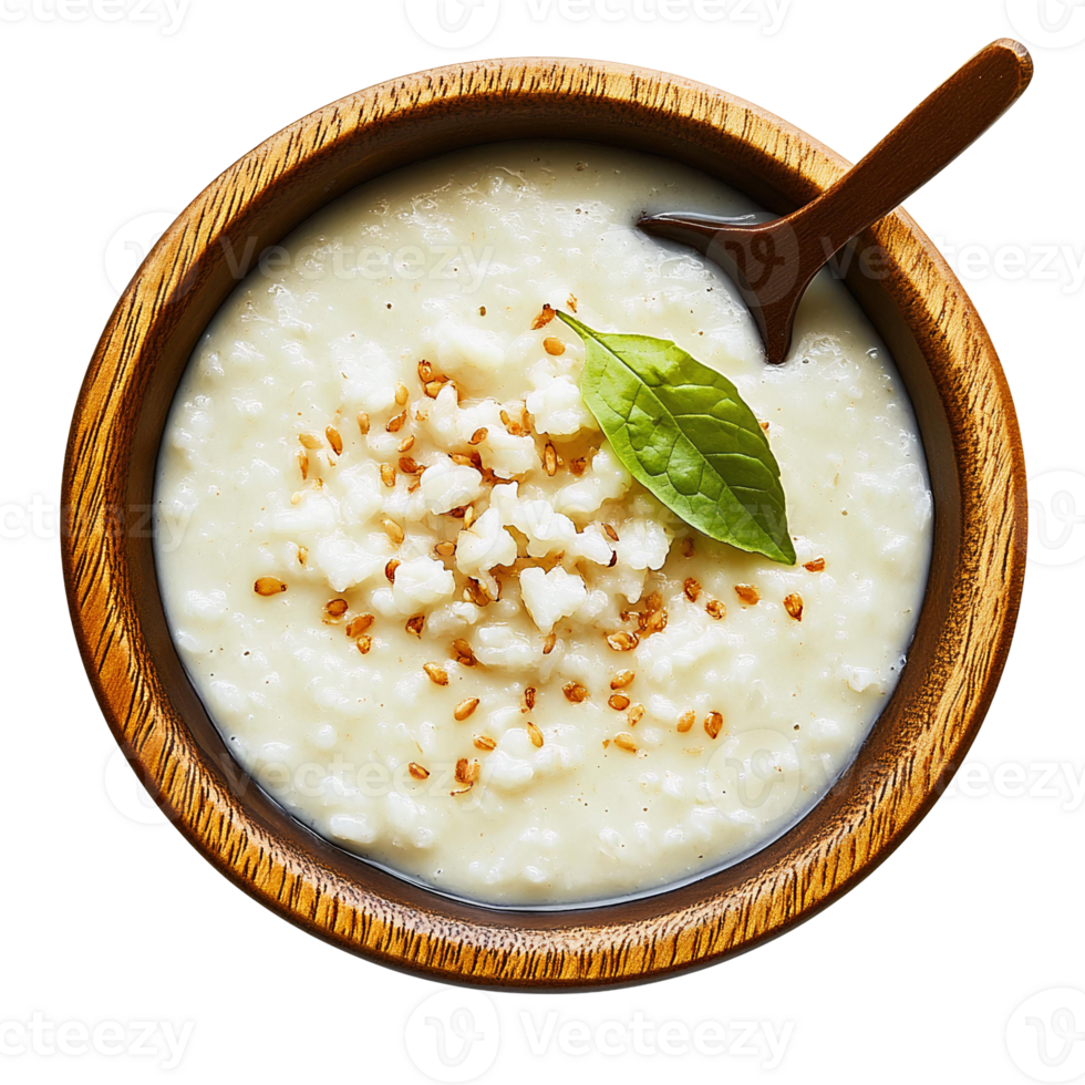 Creamy rice porridge in wooden bowl with sesame seeds and basil png