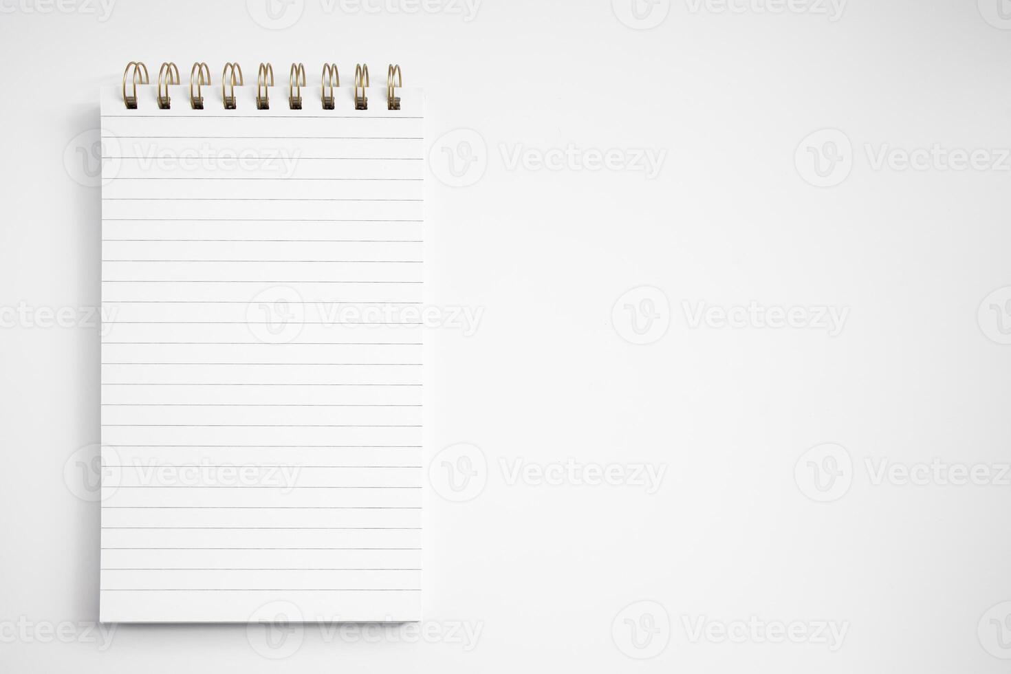 Blank notepad with lined pages on white background photo