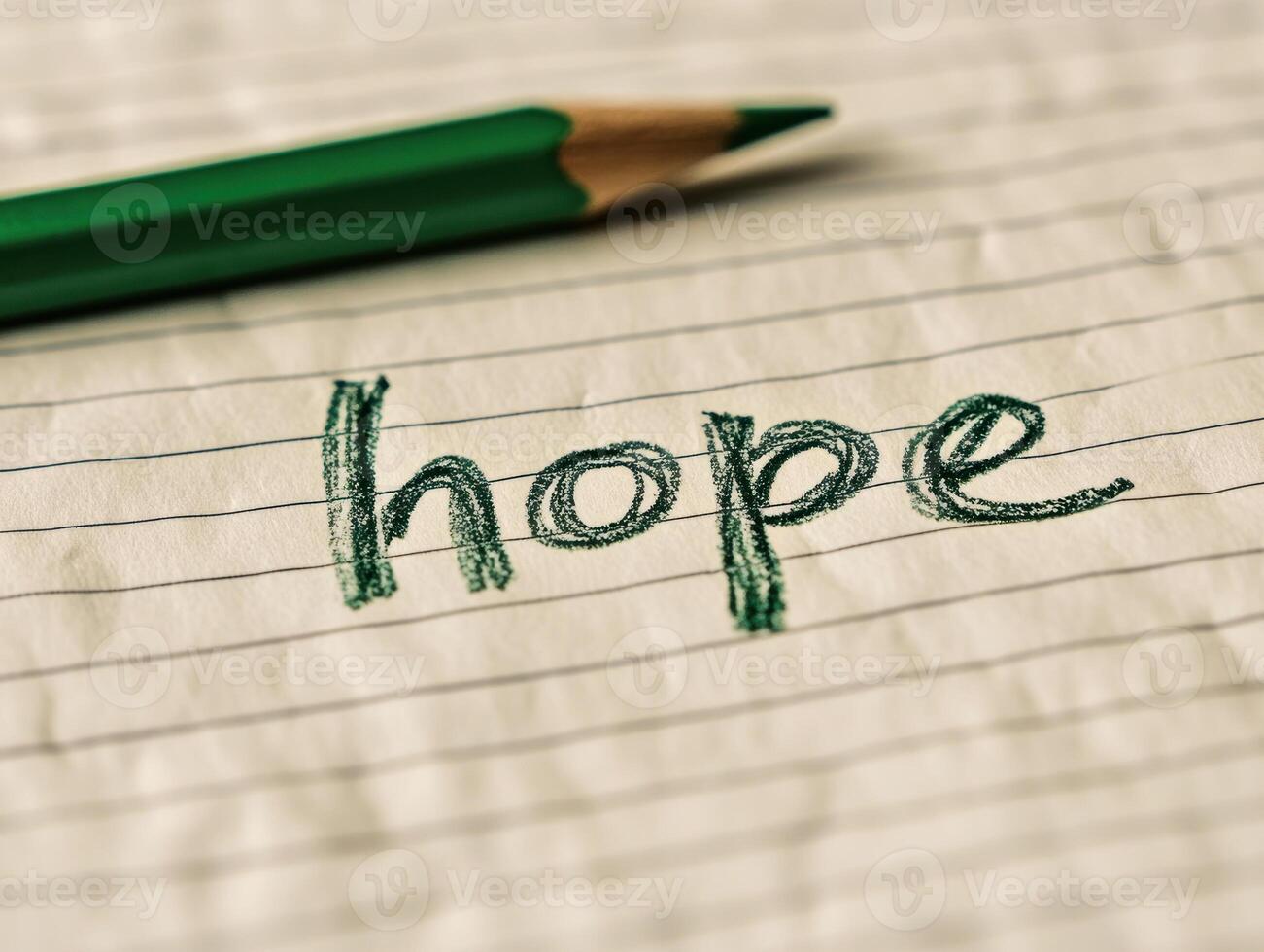 A cozy close up of hope written in childs handwriting on lined paper photo