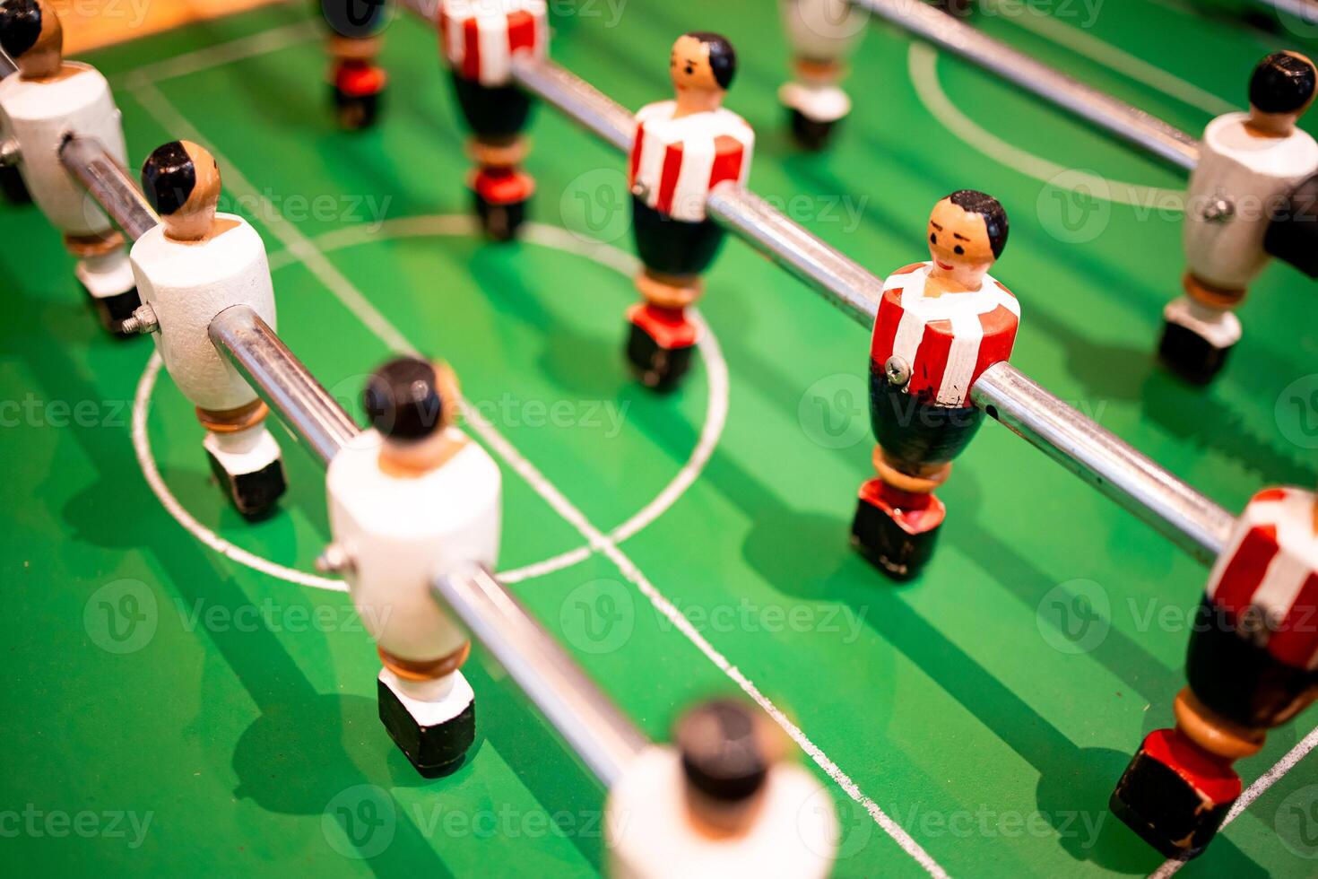Table soccer game with colorful players on green field photo