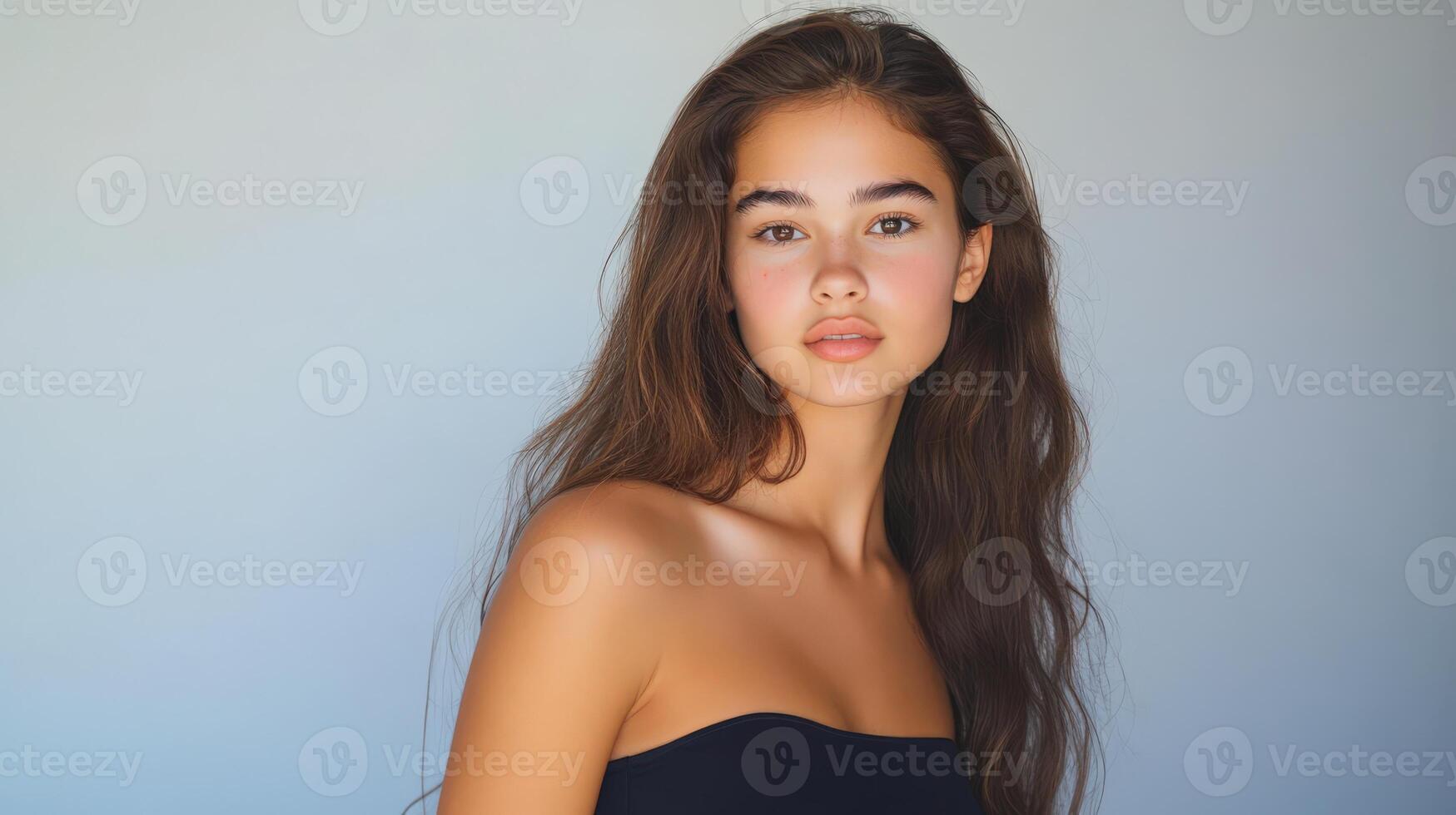 Young Woman With Long Brown Hair And Bare Shoulders photo