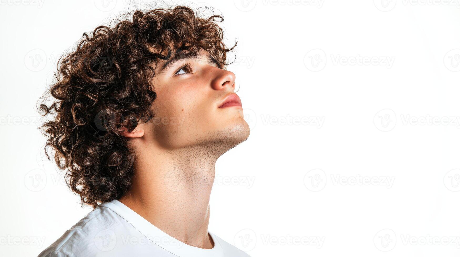 Young Man With Curly Brown Hair Looking Upward photo