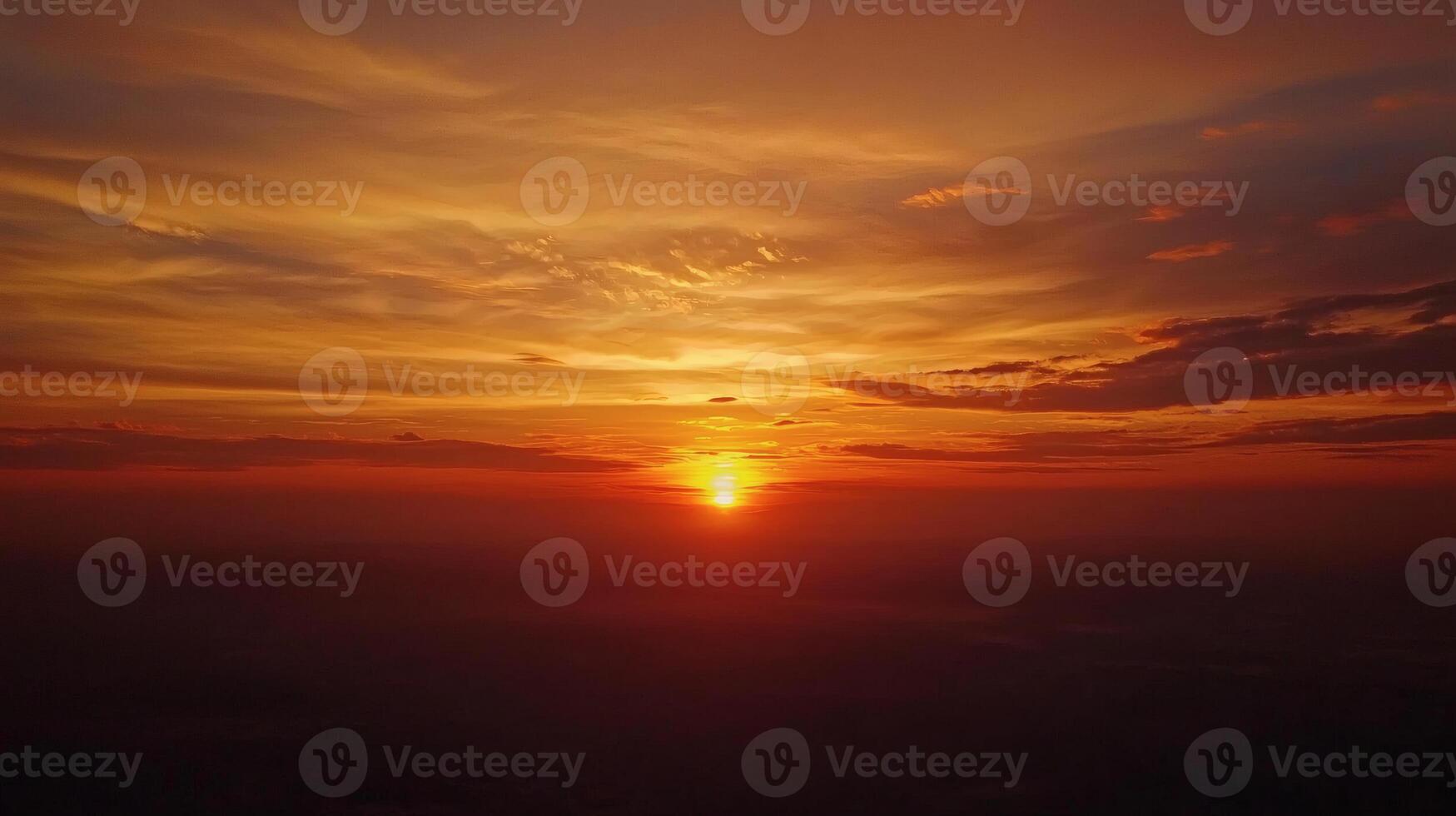 Dramatic Sunrise Over the Horizon with Fiery Sky and Clouds photo