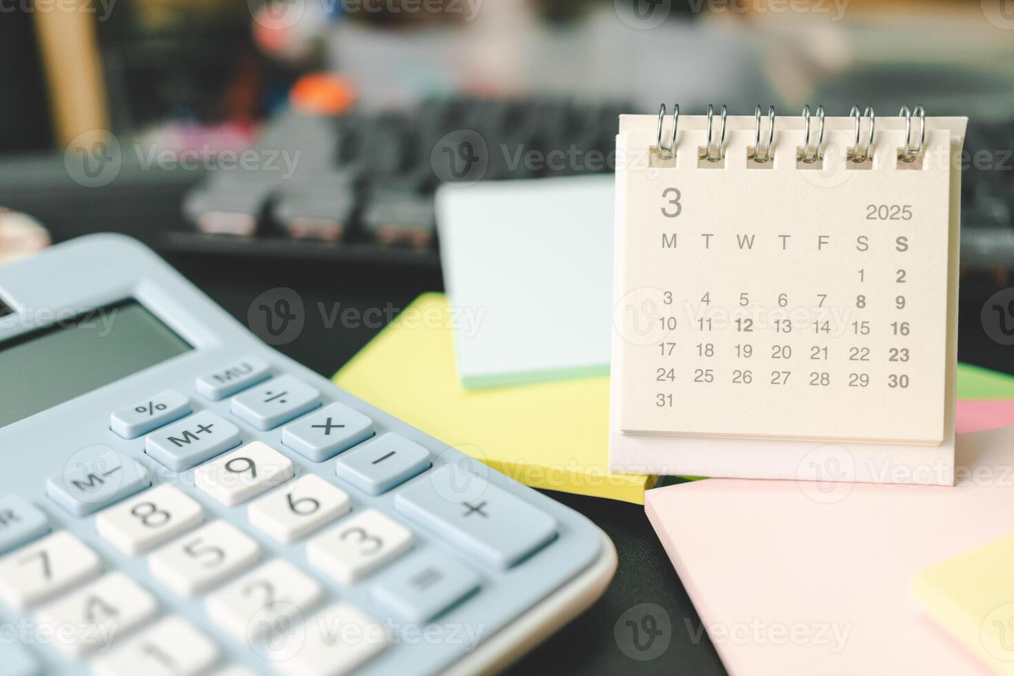 Desk calendar for MARCH 2025 with Sticky note. Calendar concept with 2025 MAR calendar. calculator and forecast for finances in 2025. Money, Budget, tax, investment and financial. photo