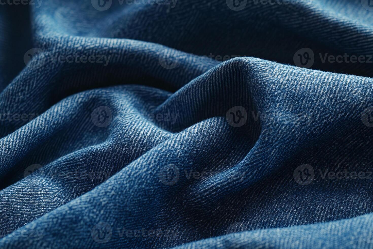 Closeup of Wrinkled Blue Denim Fabric Texture with Light and Shadow Patterns for Textile Backgrounds photo