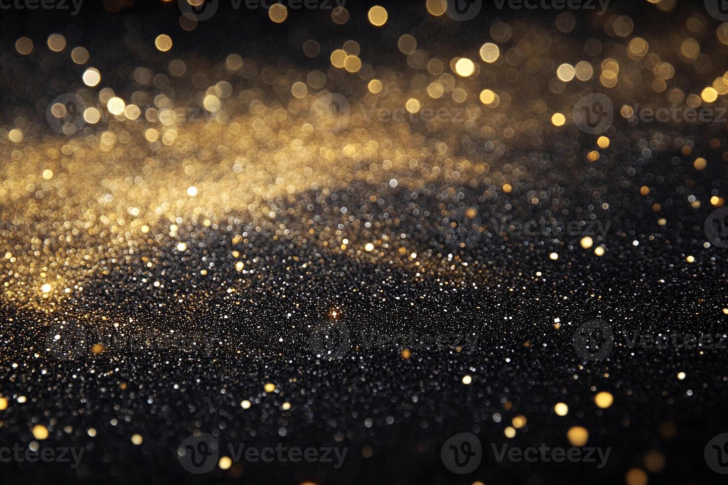 Golden Glitter Sparkles Scattered on Black Background with Abstract Bokeh Light Effect photo