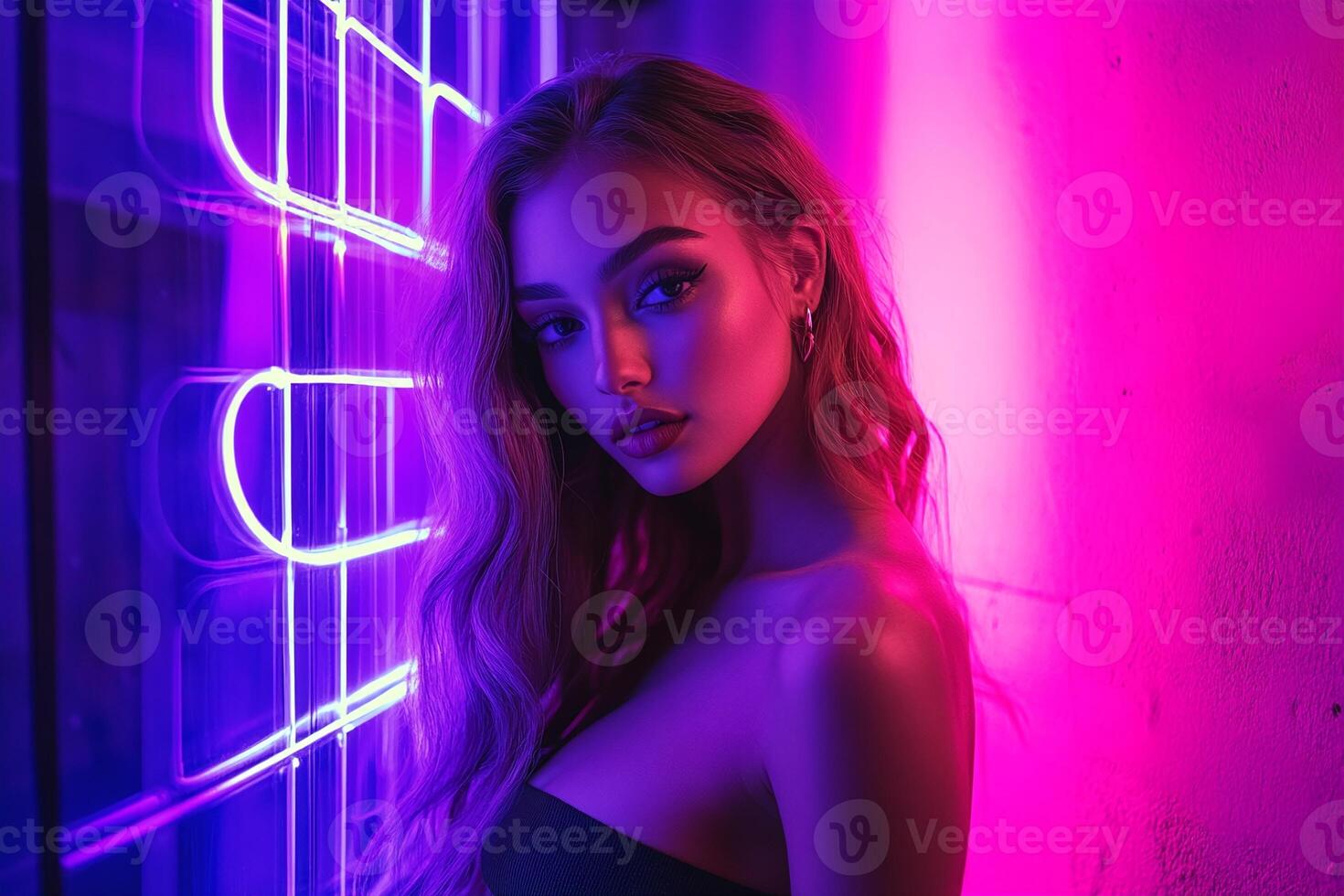 Glamorous Woman in Neon Lighting with Vibrant Pink and Purple Glow Against Urban Background photo