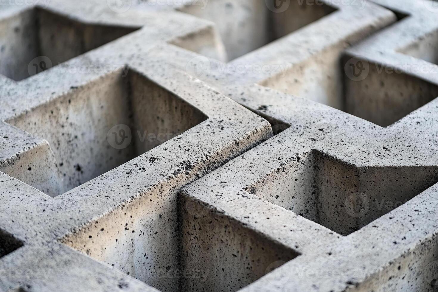 Closeup of Geometric Concrete Blocks with Symmetrical Patterns and Textured Surface in Natural Light photo