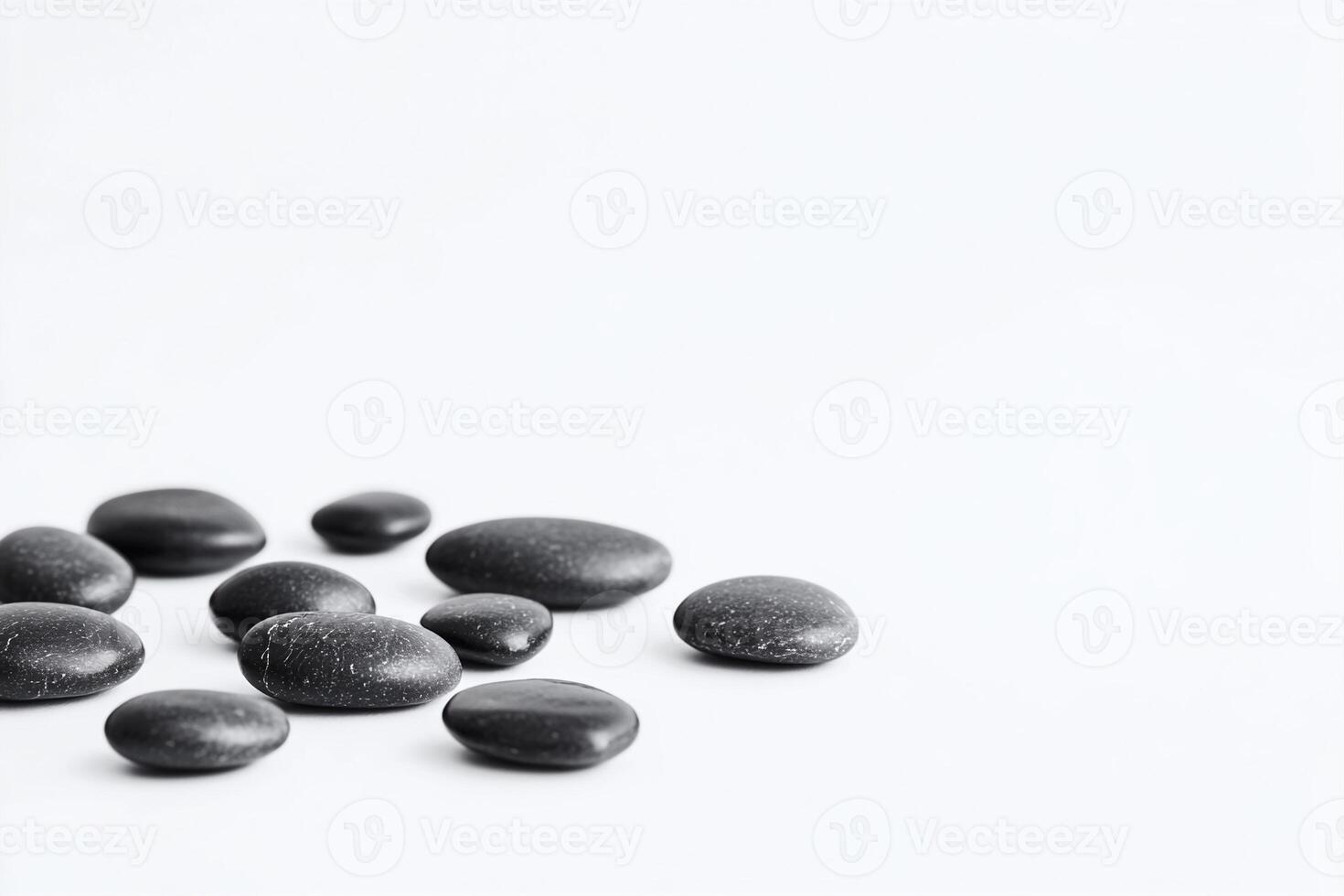 Smooth Black Spa Stones on White Background for Wellness and Relaxation Concepts photo