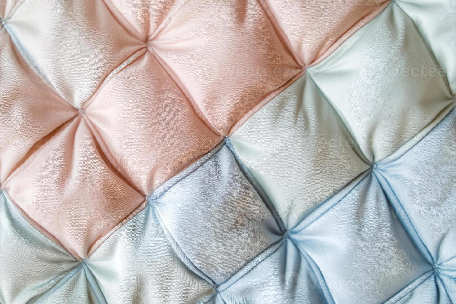 Soft Satin Fabric Texture with Quilted Pastel Peach Blue and Green Tones for Upholstery Design photo