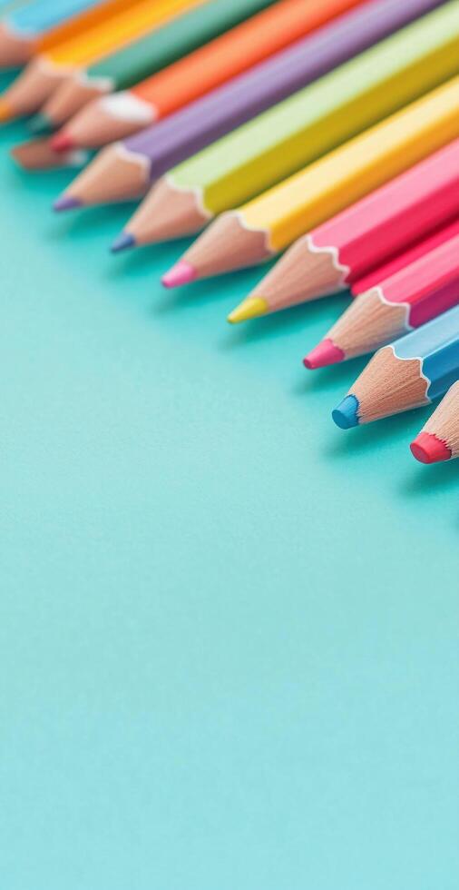 Close Up of Colored Pencils Arranged Diagonally on Light Blue Background for Creative Art Projects photo