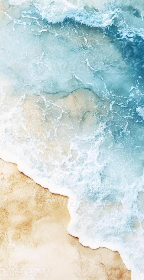 Aerial View of Turquoise Ocean Waves Crashing on Sandy Beach with Foam and Golden Shoreline photo