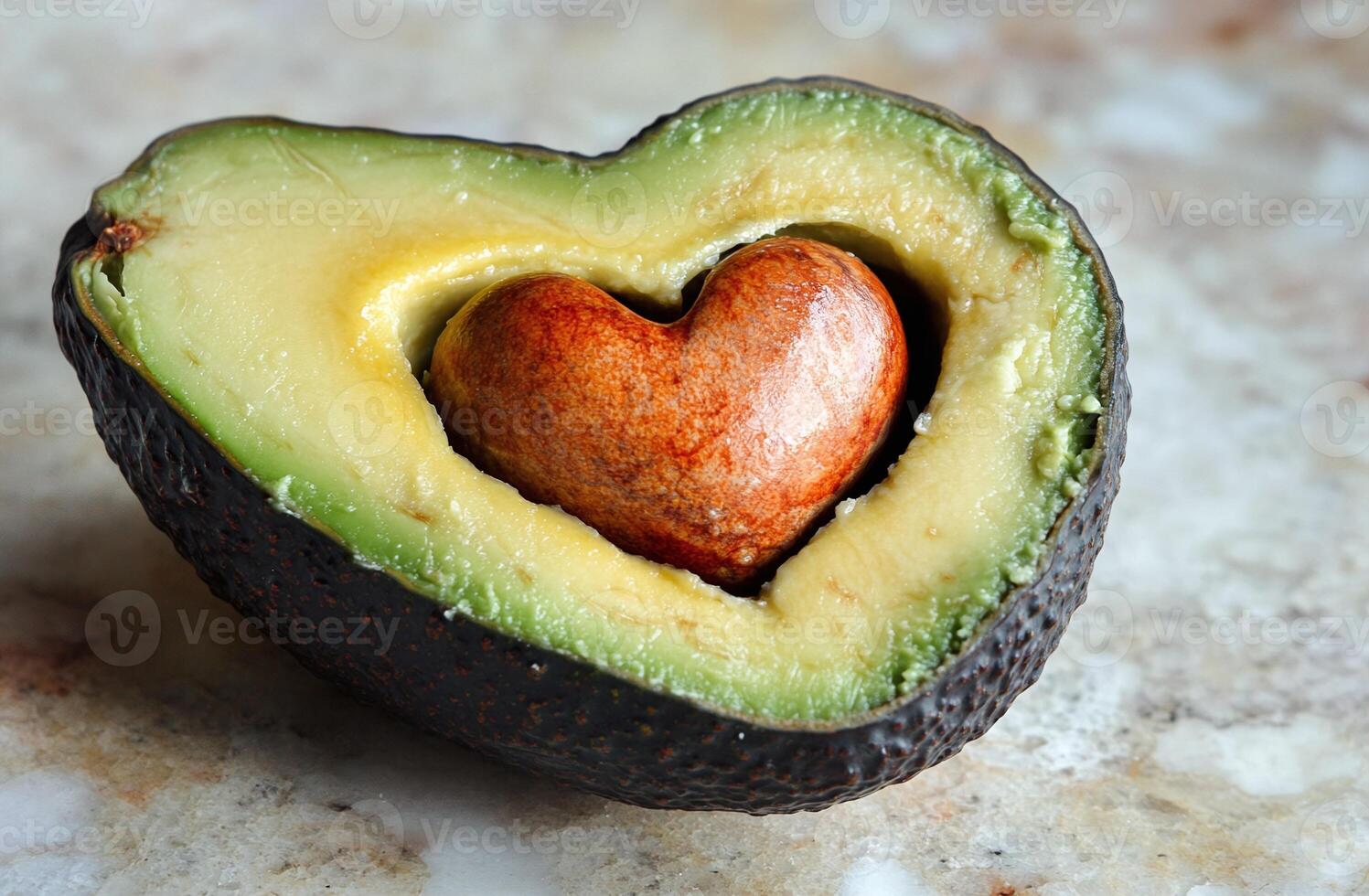 Half Ripe Avocado With Heart Shaped Seed On Marble Surface For Healthy Eating Concepts photo