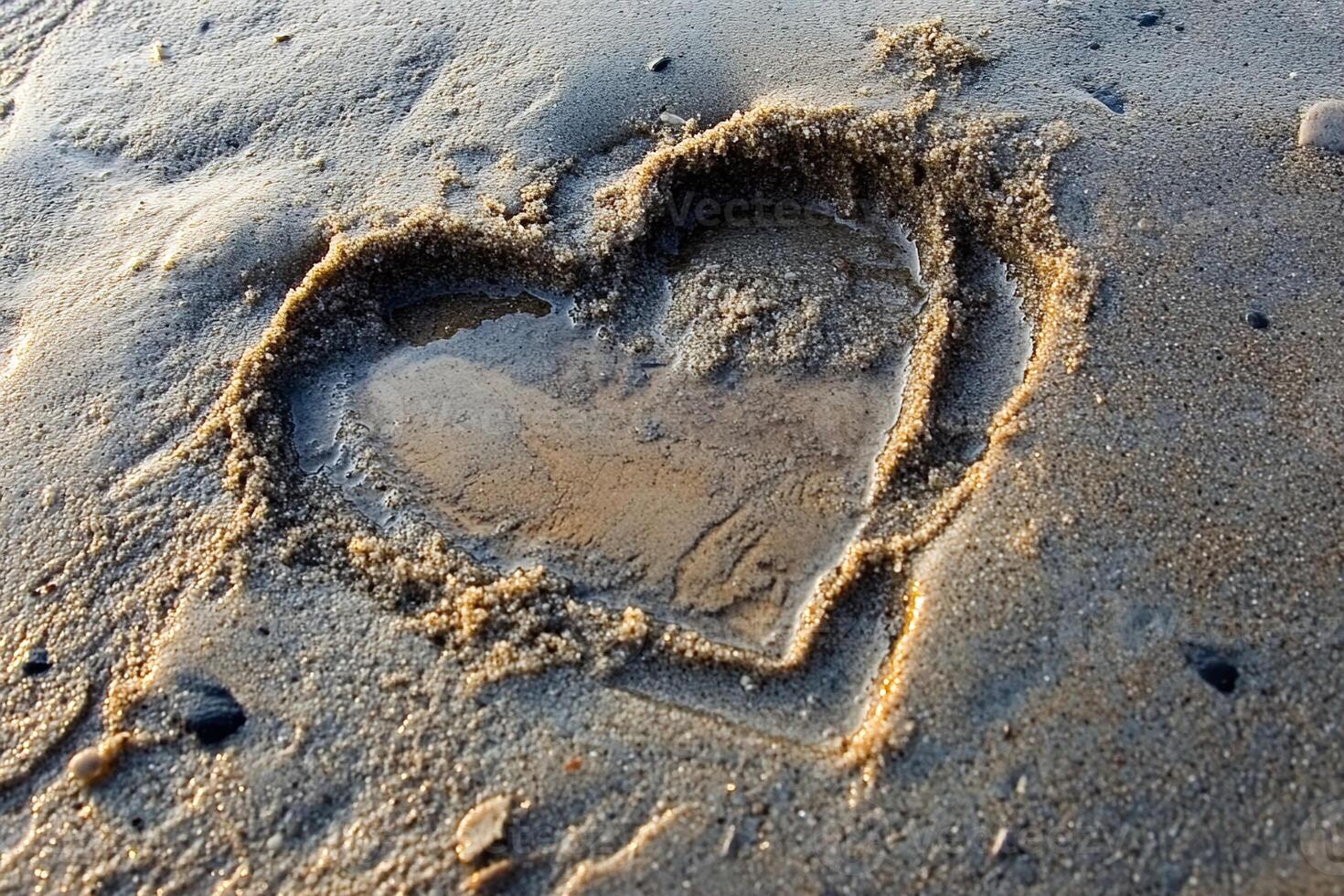 Heart Shape Drawn in Wet Sand with Water on Shoreline at Sunset Reflecting Golden Light photo