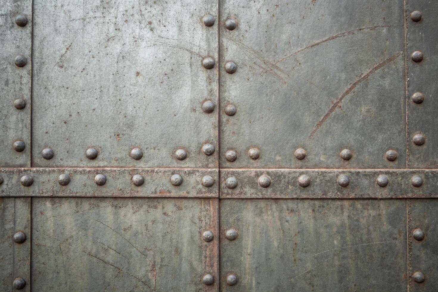 A close up of a metal door with rivets photo