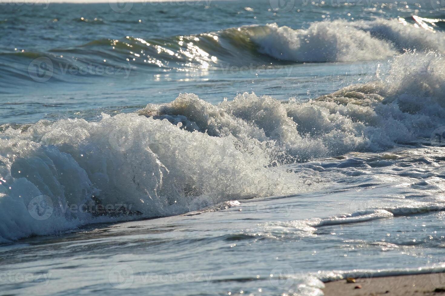 A person is surfing on the ocean waves photo