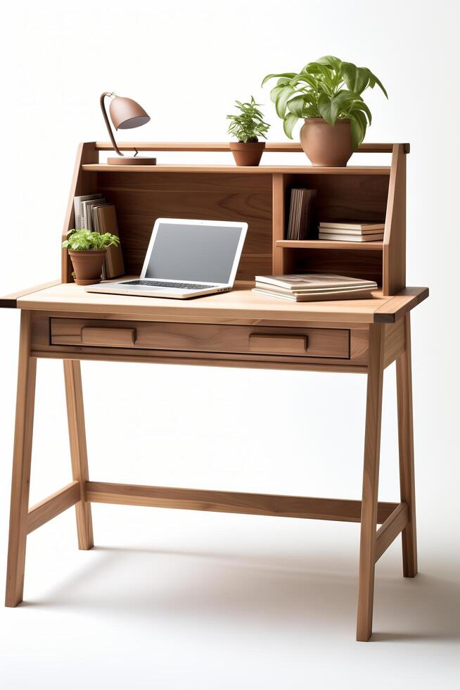 A desk with a laptop and a plant on it photo