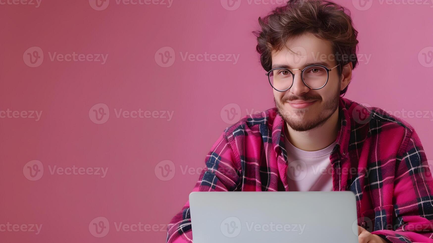 Young Technical Writer Exuding Joy while Creating Content on a Colorful Background photo