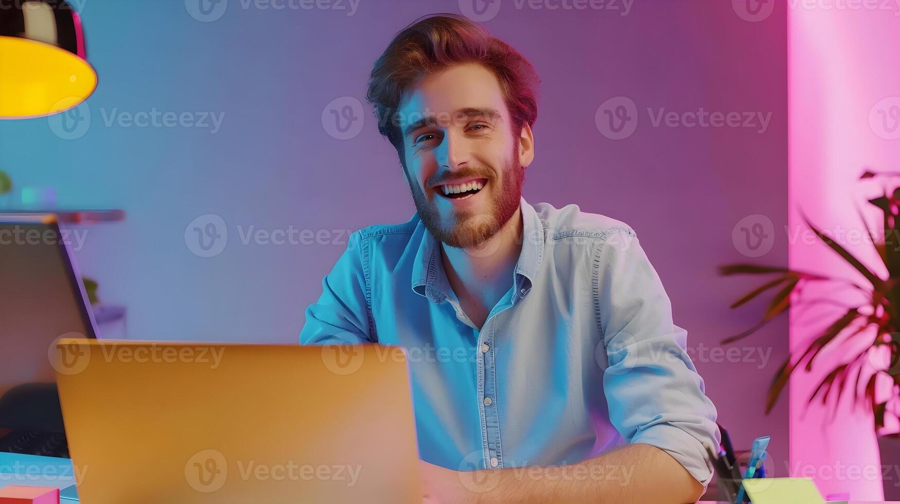 Cheerful Young Professional Businessman Working on Laptop in Modern Office photo